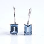 A modern pair of 18ct white gold aquamarine earrings, set with emerald-cut aquas on shepherd hook