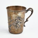 A small Art Nouveau German silver mug, relief embossed floral decoration with natural formed handle,