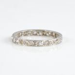 An early 20th century unmarked white metal diamond eternity ring, set with 26 round eight-cut