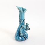 A Chinese turquoise glaze pottery figure mounted spill vase, height 18cm