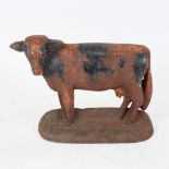 A Vintage painted cast-iron cow doorstop, height 16cm, length 22cm