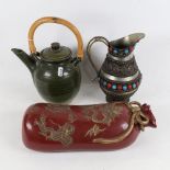 An Oriental ceramic pillow with embossed decoration, length 33cm, a tea kettle, and a stone set