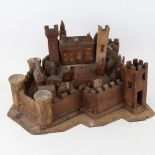 A carved and stained wood hilltop town and castle display, possibly of St Michael's Mount, base