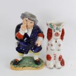 2 pieces of Staffordshire pottery, comprising Standing Toby Taking Snuff, and a Spaniel jug, largest