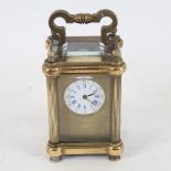 A modern brass-cased miniature carriage clock, bevelled glass exhibition viewing plates, case height