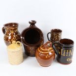 A group of slip glaze earthenware pottery, including Guinness tankard, large salt pot etc, largest