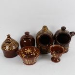 A group of slip glaze earthenware pottery, including money boxes, salt pots etc, largest height 14cm
