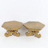 A pair of gilded hexagonal wooden stands, on tripod supports, 22cm across