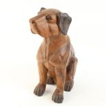 A large carved hardwood seated dog, height 38cm