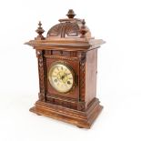 A 2-train mantel clock in carved oak case, height 42cm