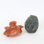 A Chinese carved and polished jadeite figural snuff bottle, and a Chinese carnelian pot and cover,