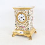 An ornate 19th century French ceramic 8-day mantel clock, with brass mounts and gilt decoration