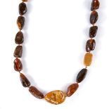 A graduated single-strand Baltic amber bead necklace, largest bead length 29.9mm, necklace length