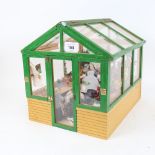 A handmade garden greenhouse diorama, with various fittings, length 32cm, height 28cm