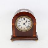 A lacquered and inlaid mahogany dome-top mantel clock, printed dial with Roman numeral hour markers,