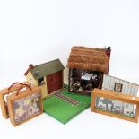 A handmade thatched doll's house, a model outhouse, and 3 diorama cabinet scenes (5)