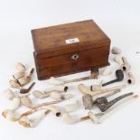 A group of 19th century clay pipes, including figural and Rye examples, in stained pine storage box,