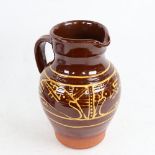 A slip glaze stoneware pottery jug, height 21cm