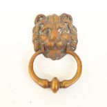 A large cast-brass lion mask door knocker, mask height 13cm