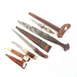 Various knives and daggers, including Middle Eastern Damascus Kris with hardwood scabbard, blade