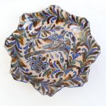 A 19th century Spanish faience frilled bowl, underglaze painted dove and floral decoration, diameter