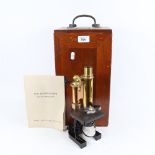A brass student's microscope by E. Leitz Wetzlar, in fitted mahogany case with accessories, case