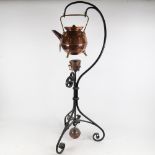 An Arts and Crafts design copper and brass tea kettle, 22.5cm, with burner on wrought-iron stand