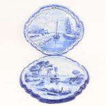 A pair of Delft blue and white pottery wall plaques, with painted river scenes, width 38cm, height