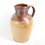 A very large stoneware pottery jug, height 40cm (handle restored)