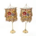 A pair of 19th century Berlin beadwork face screens, mounted on original gilt-brass stands, on
