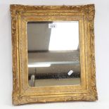 An ornate gilt-gesso mirror, overall 45cm x 39cm