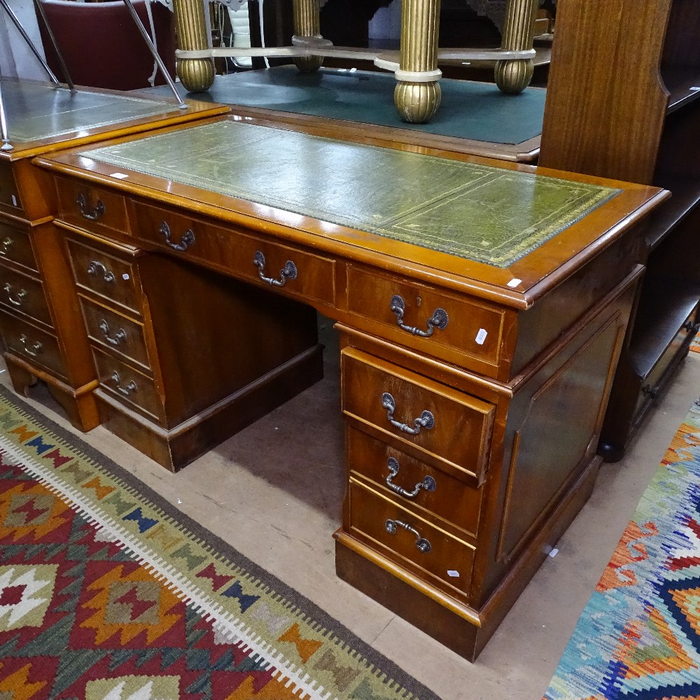 A reproduction yew wood twin-pedestal writing desk, W124cm, H77cm, D62cm, kneehole width 53cm and