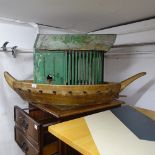 A stained wood boat hull, and a Vintage painted wood birdbox