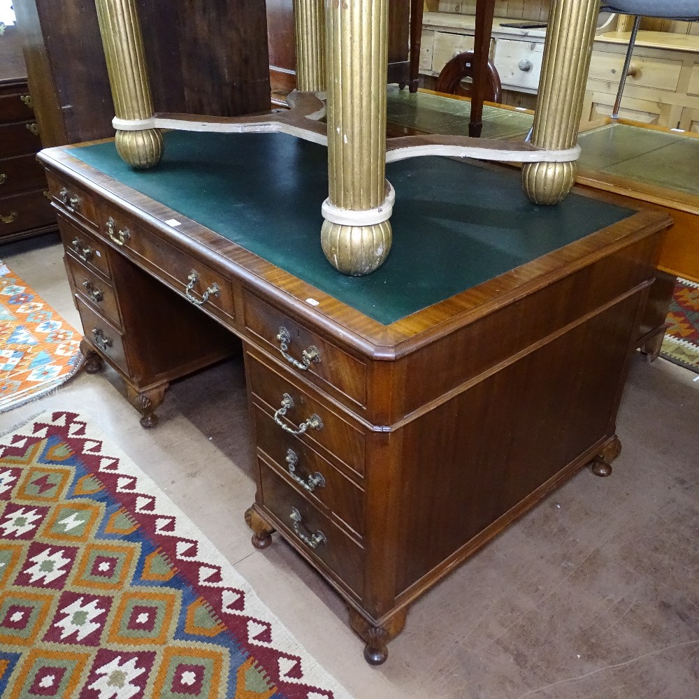 An Edwardian mahogany twin-pedestal writing desk, W153cm, H78cm, D91cm, kneehole width 58cm and
