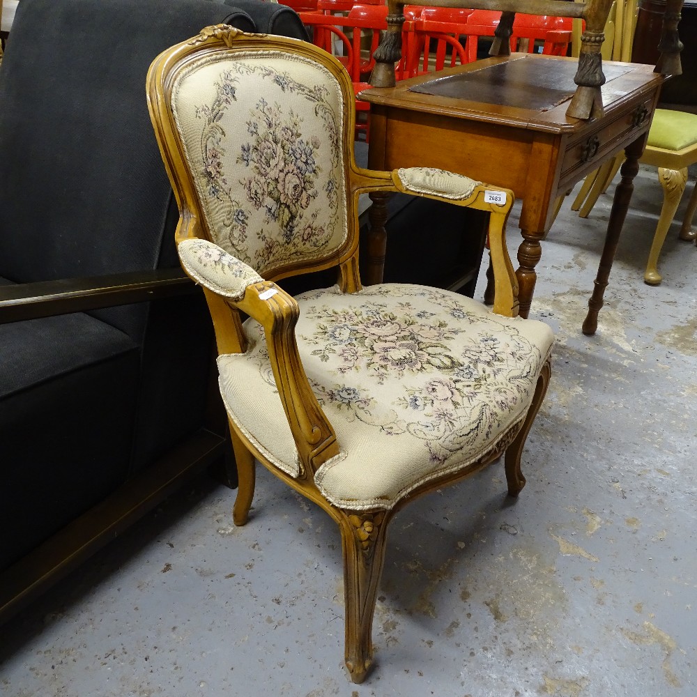 A Continental carved and stained beech-framed open-arm bedroom chair, with tapestry panels