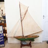 A large 19th century green painted wooden hulled model pond yacht, with sails and rigging, hull