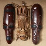 A large pair of African Tribal wall-hanging face masks, and a carved hardwood Balinese medicine