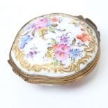 An early 20th century Continental porcelain clam shell trinket box, hand painted and a gilded floral