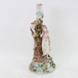 A 19th century German porcelain figural candlestick, surmounted by lady and cherub, overall height