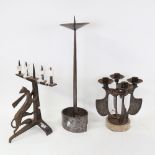 A group of Arts and Crafts style planished and wrought-metal candlesticks, including figural cricket