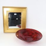 A rectangular gilt-framed wall mirror, and a red and black Art glass bowl, diameter 40cm (2)