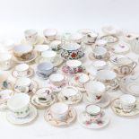 A large group of miniature doll's house porcelain teacups and saucers, including Spode