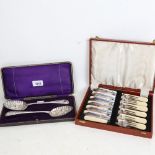 A cased pair of silver plated berry spoons, and a cased fish eating set for 6 people