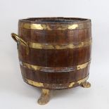 A large coopered oak coal barrel, with lion paw feet and zinc liner, height 40cm, diameter 38cm