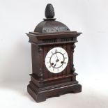 An oak-cased 8-day mantel clock by Junghans, with gong and pendulum, height 50cm