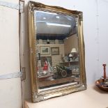 A large rectangular gilt-framed bevel-edge wall mirror, overall 76cm x 106cm