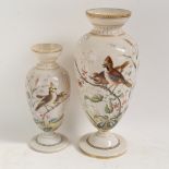 A graduated pair of Victorian milk glass vases, hand painted and gilded bird and floral