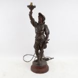 A large bronzed spelter figural table lamp, rifleman holding a torch, height 57cm