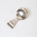 An Elizabeth II silver tea caddy spoon, textured handle with planished bowl, maker's marks JA,