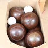 A set of 8 lignum vitae lawn bowls, and 2 white ceramic jacks by F H Ayres Ltd of London